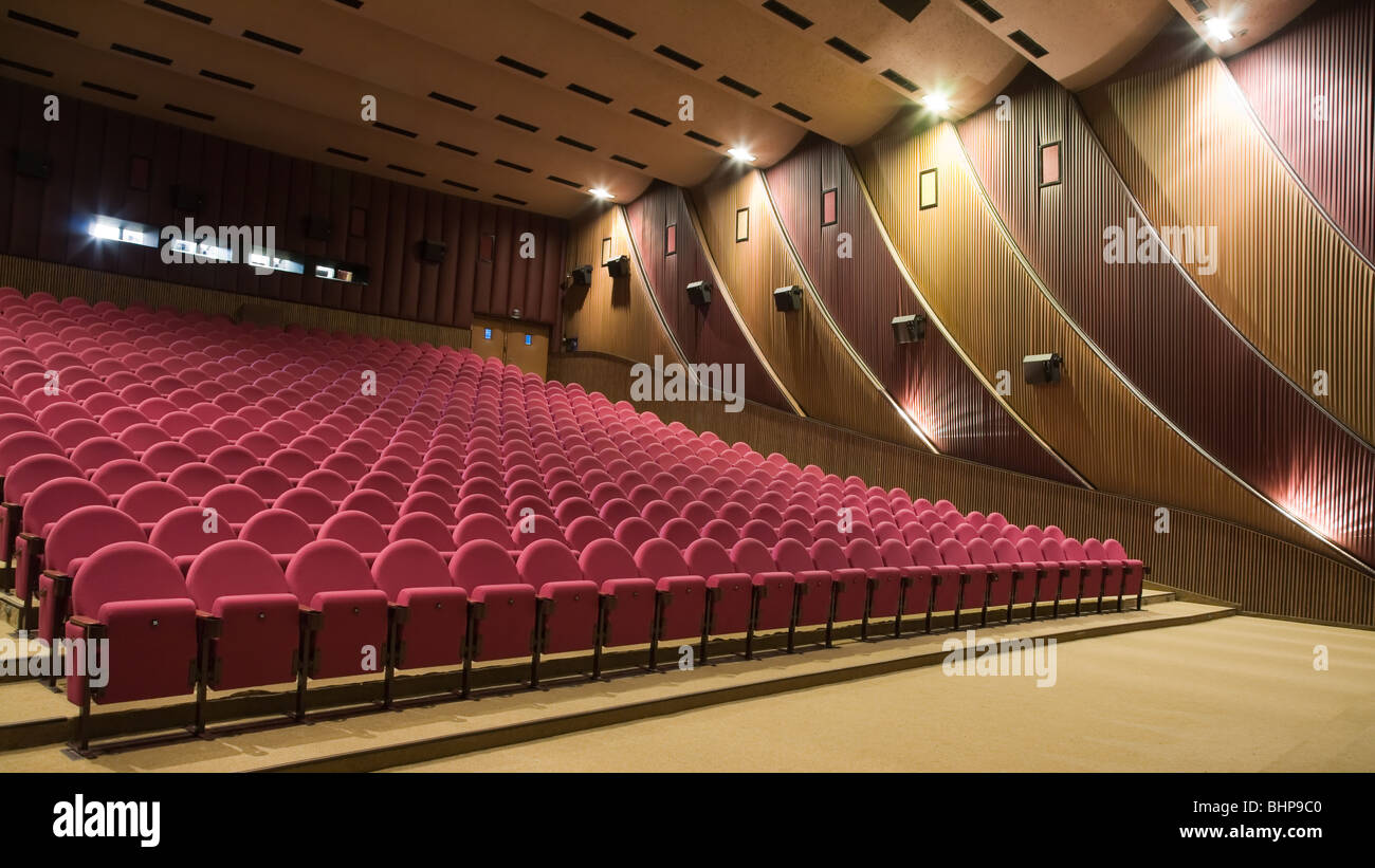 Empty cinema auditorium line of pink chairs. Stock Photo