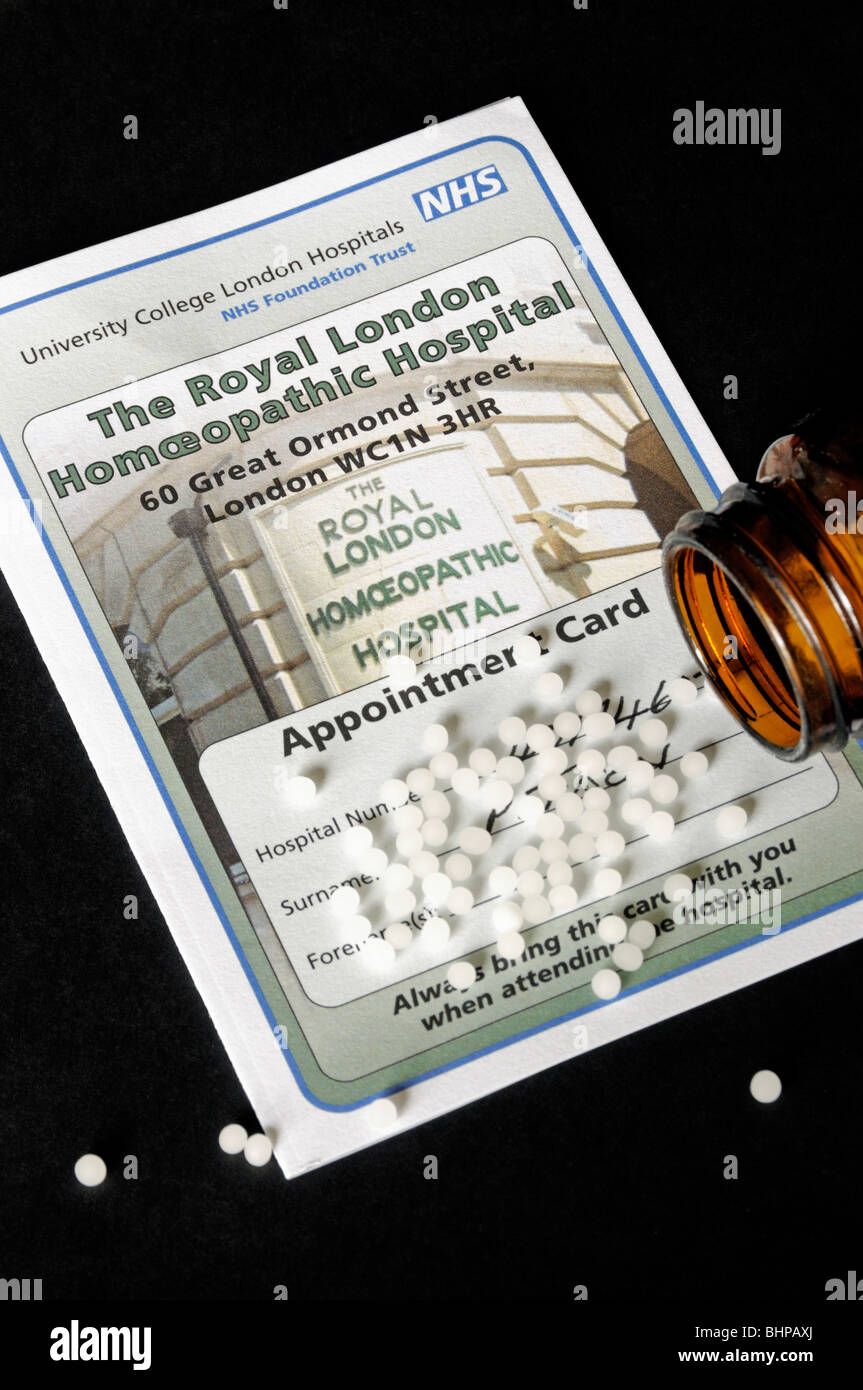 The Royal London Homoeopathic Hospital Appointment Card with spilt pills on black background Stock Photo