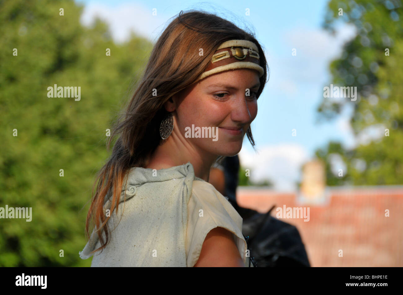 Pretty young woman in medieval garb in the Lithuanian countryside Stock Photo