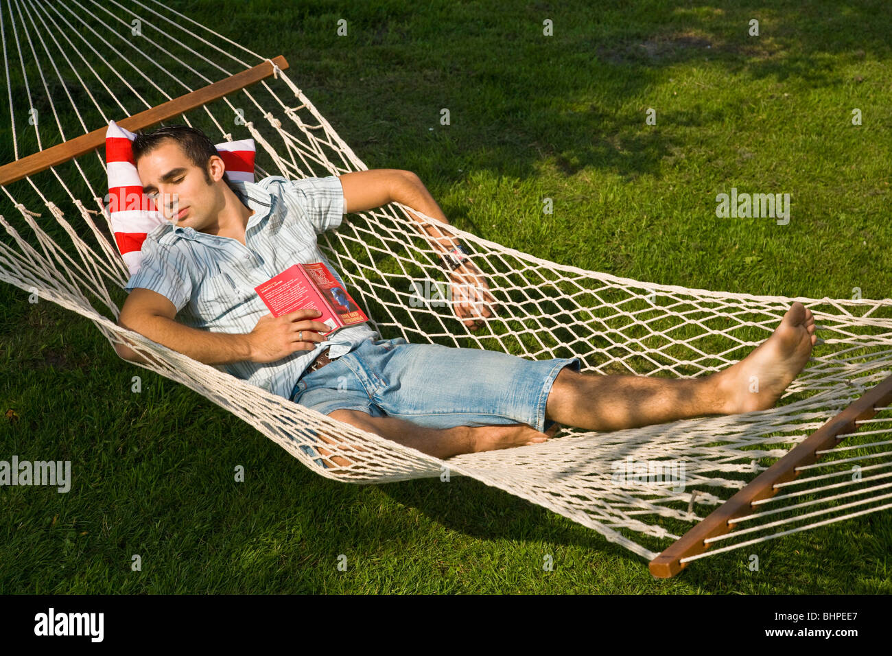 Young man lying in hammock sleeping Stock Photo Alamy
