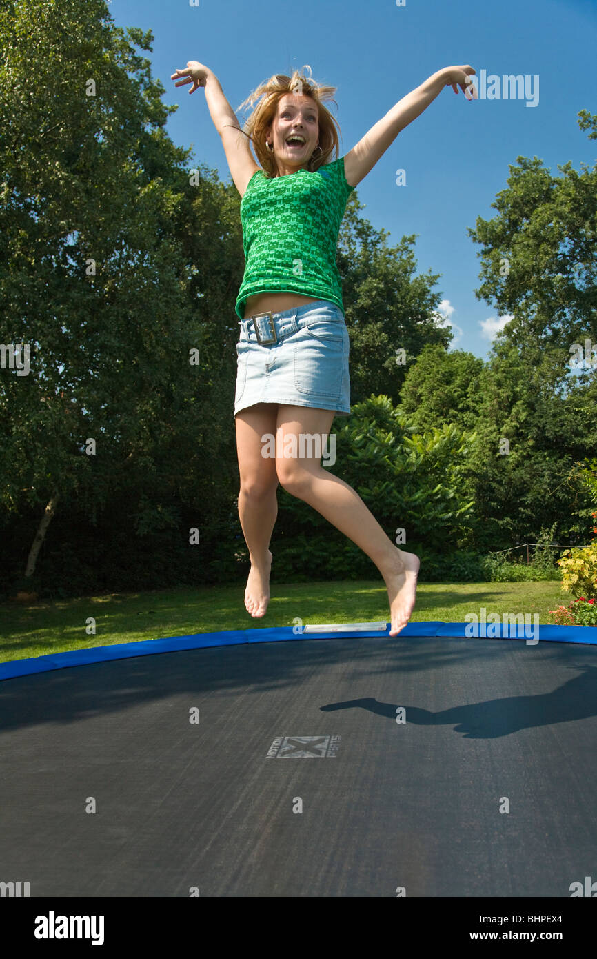 Young woman jumping on a trampoline Stock Photo - Alamy