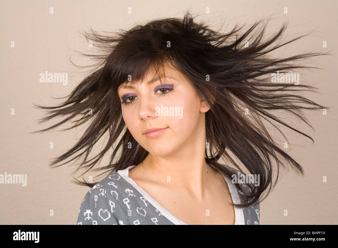 Beautiful brunette doing hair flip Stock Photo