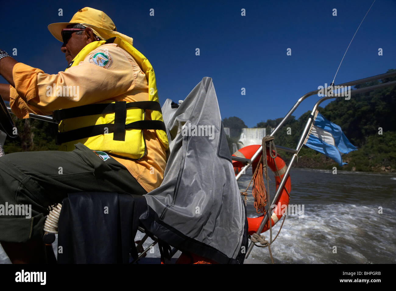 local tour guide driving speed boat past waterfalls at iguazu national park, republic of argentina, south america Stock Photo