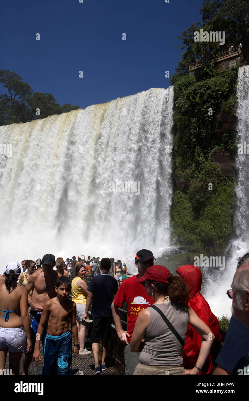 tourists at viewpoint underneath the adan y eva adam and eve fall on the lower circuit in iguazu national park argentina Stock Photo