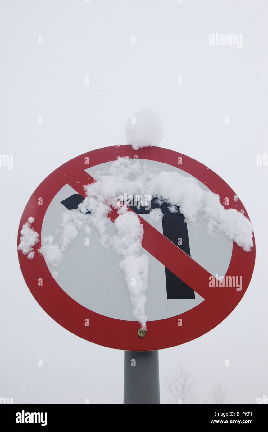 No left turn sign covered with snow in Manchester UK Stock Photo