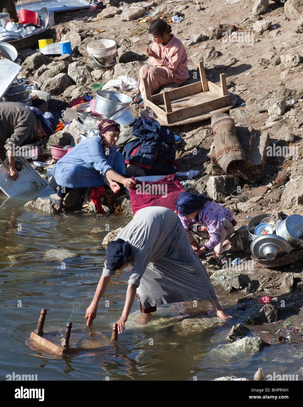 women washing dishes and clothes in canal, Fayyoum oasis, Egypt Stock Photo  - Alamy