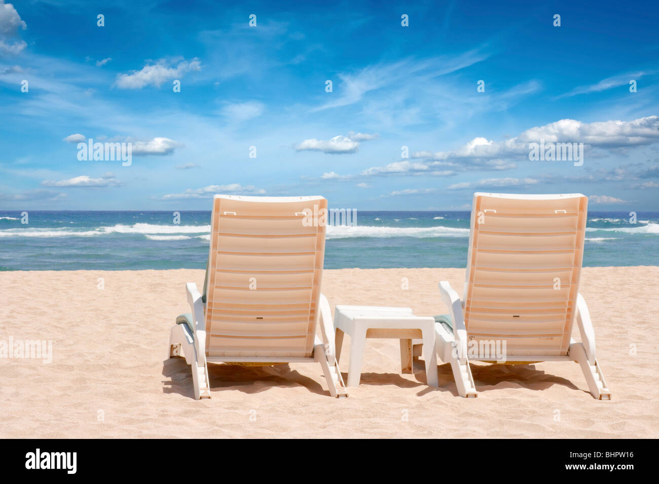 Two chaise longues on beach near ocean Stock Photo Alamy