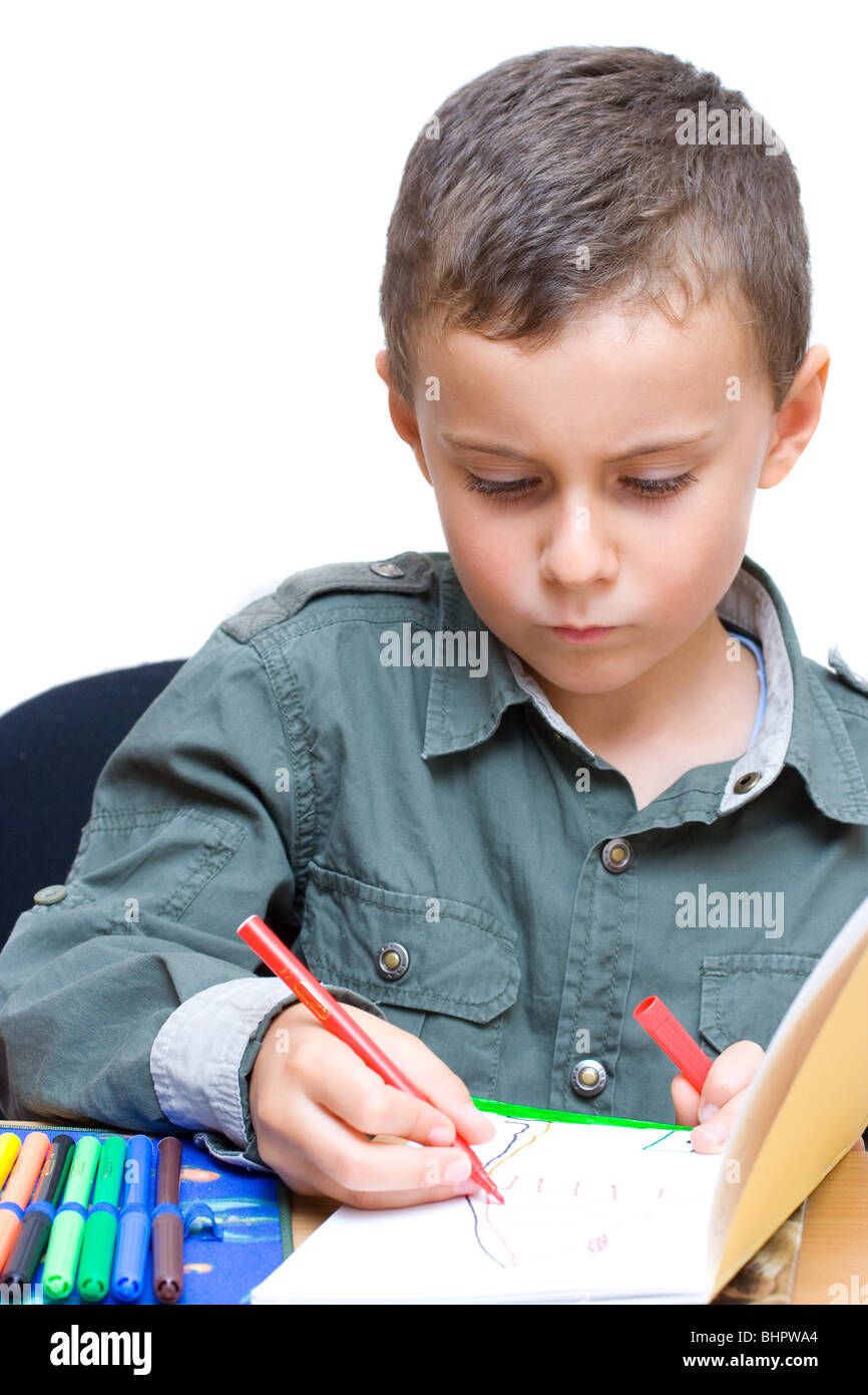 Portrait of a cute schoolboy drawing Stock Photo - Alamy