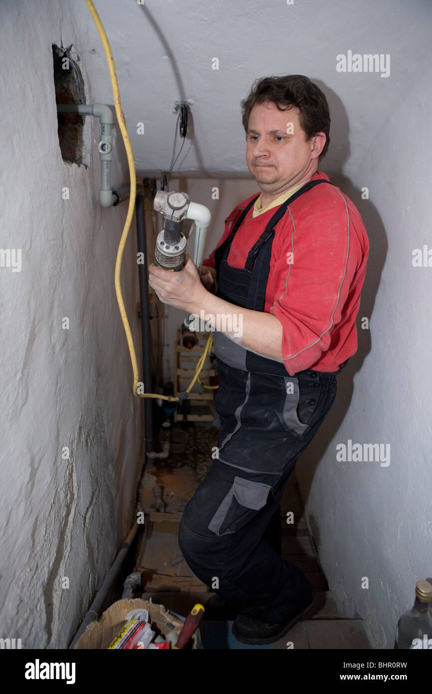 Plumber in action. Stock Photo