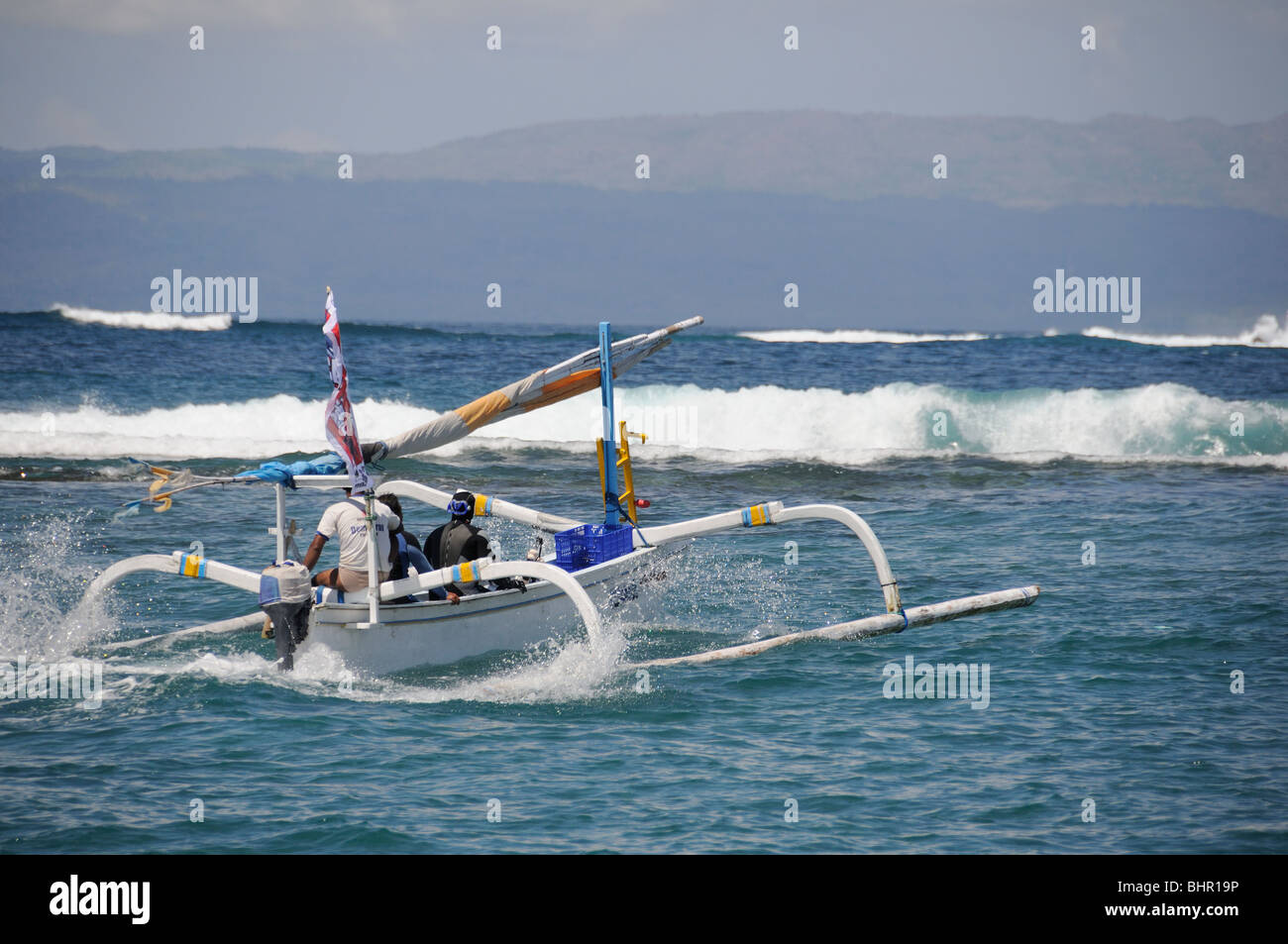 Outrigger-Canoe riding against big waves, Bali, Indonesia, Indo-Pacific Ocean Stock Photo