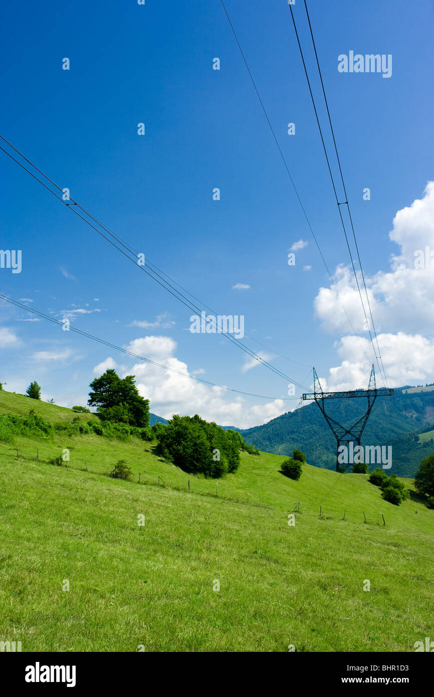 Power lines towers over blue sky Stock Photo - Alamy