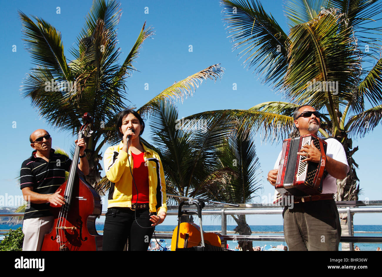 Group of Spanish gypsy musicians busking near Las Canteras beach in Las Palmas, Gran Canaria Stock Photo
