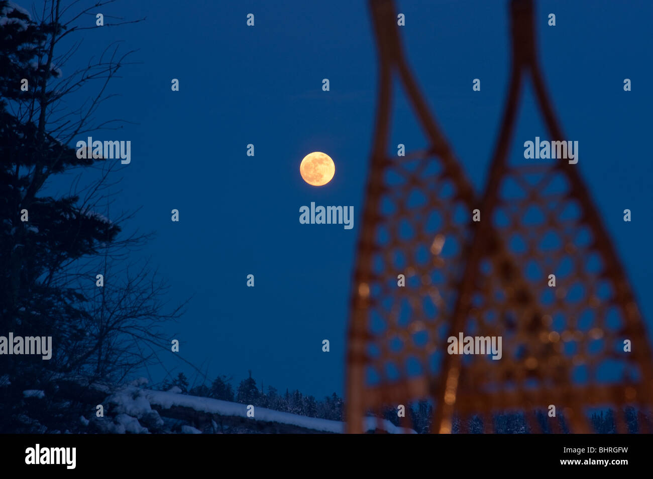 A FULL MOON RISES BEHIND SNOWSHOES QUETICO Stock Photo