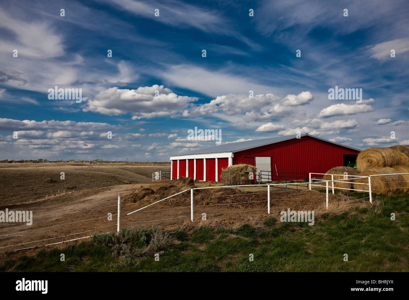 Red farm house with the cloudy blue skies Stock Photo - Alamy