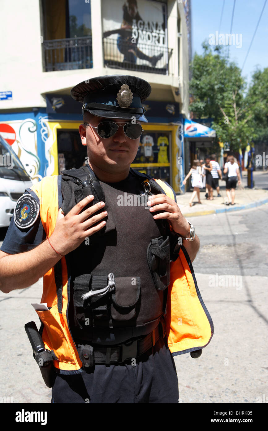 argentine policia federal armed police officer guards street corner in