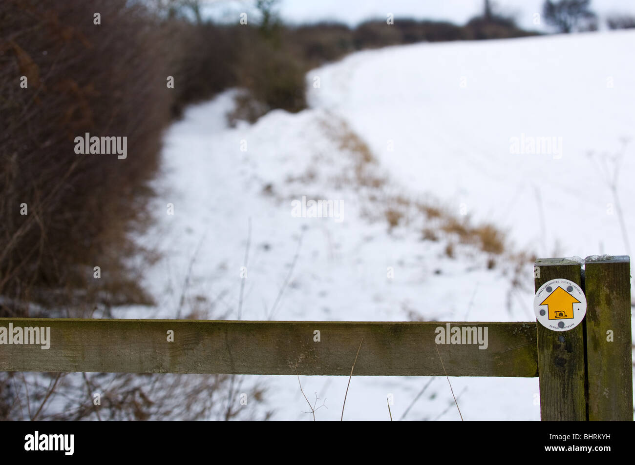 Post arrows showing direction of public footpaths in the winter after a ...