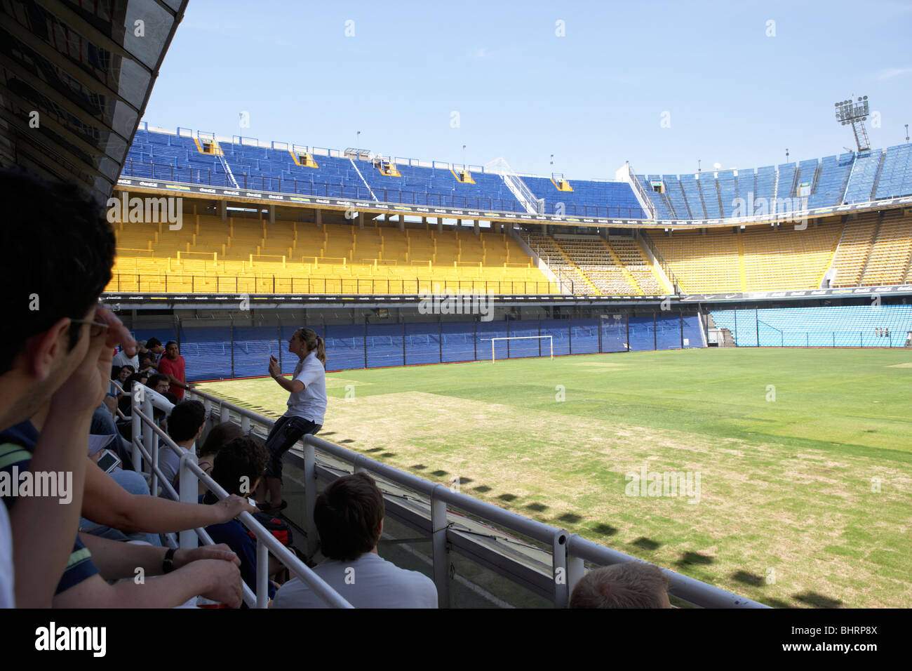 tour group with guide in the stand interior of Alberto J Armando la bombonera stadium home to atletico boca juniors Stock Photo