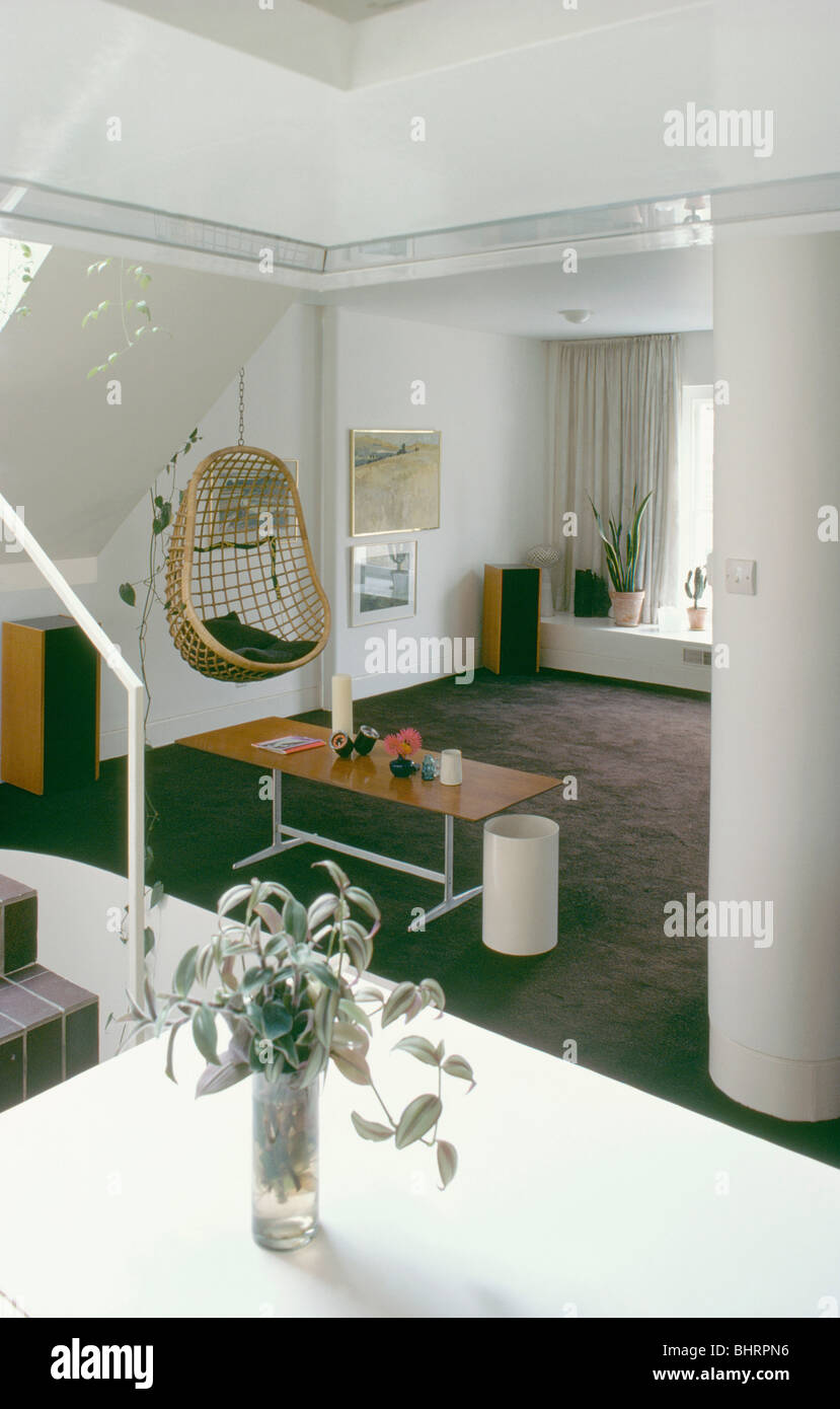 Open Plan White Sixties Living Room With Cane Egg Chair Suspended