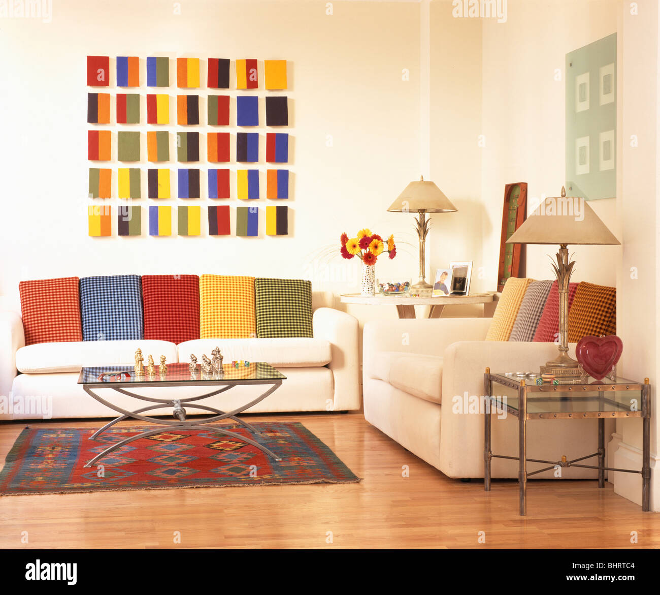 Brightly colored geometric picture above white sofa with colorful ...