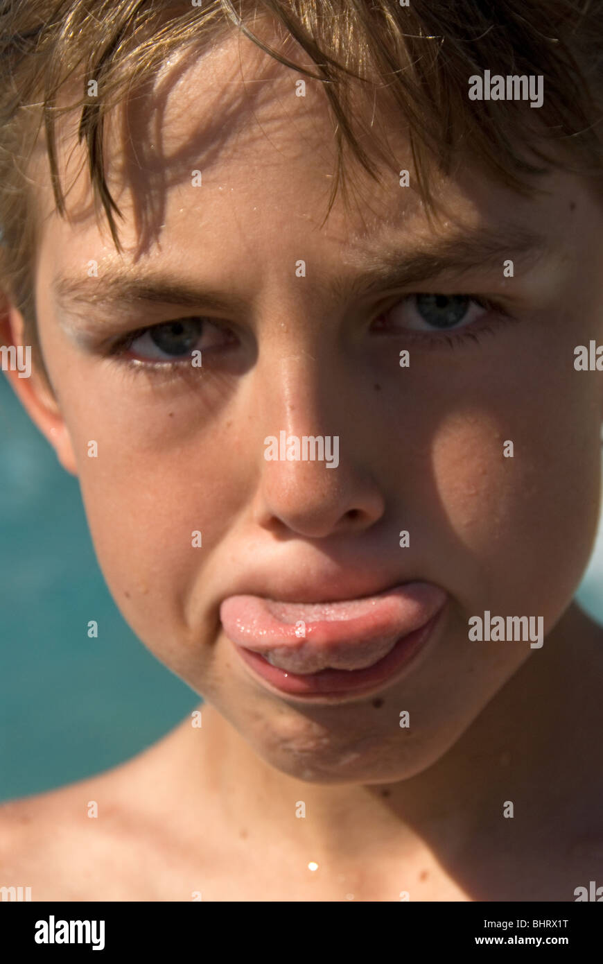 Young boy sticking his tongue out Stock Photo Alamy
