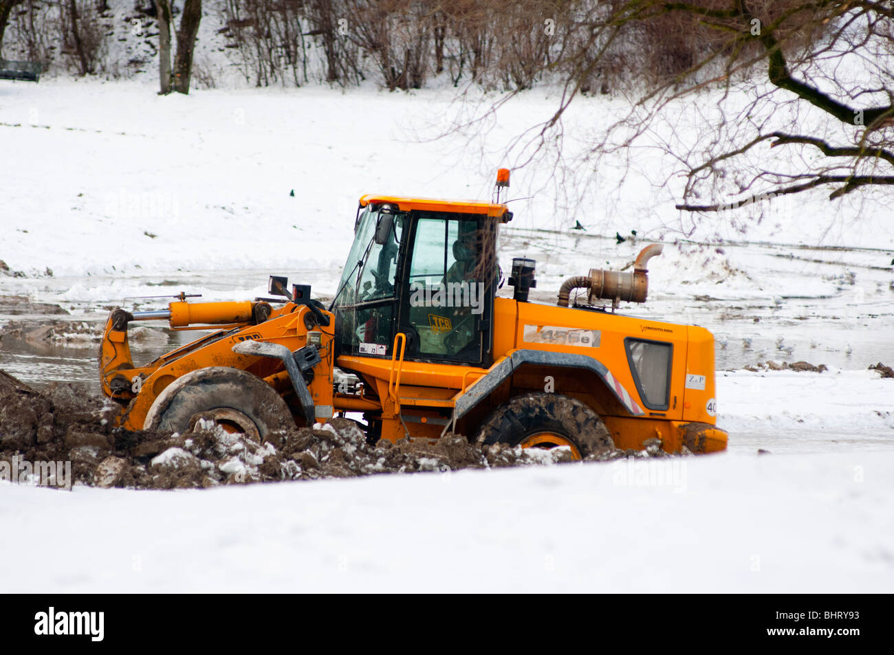 Bulldozer deep in mud and snow Stock Photo