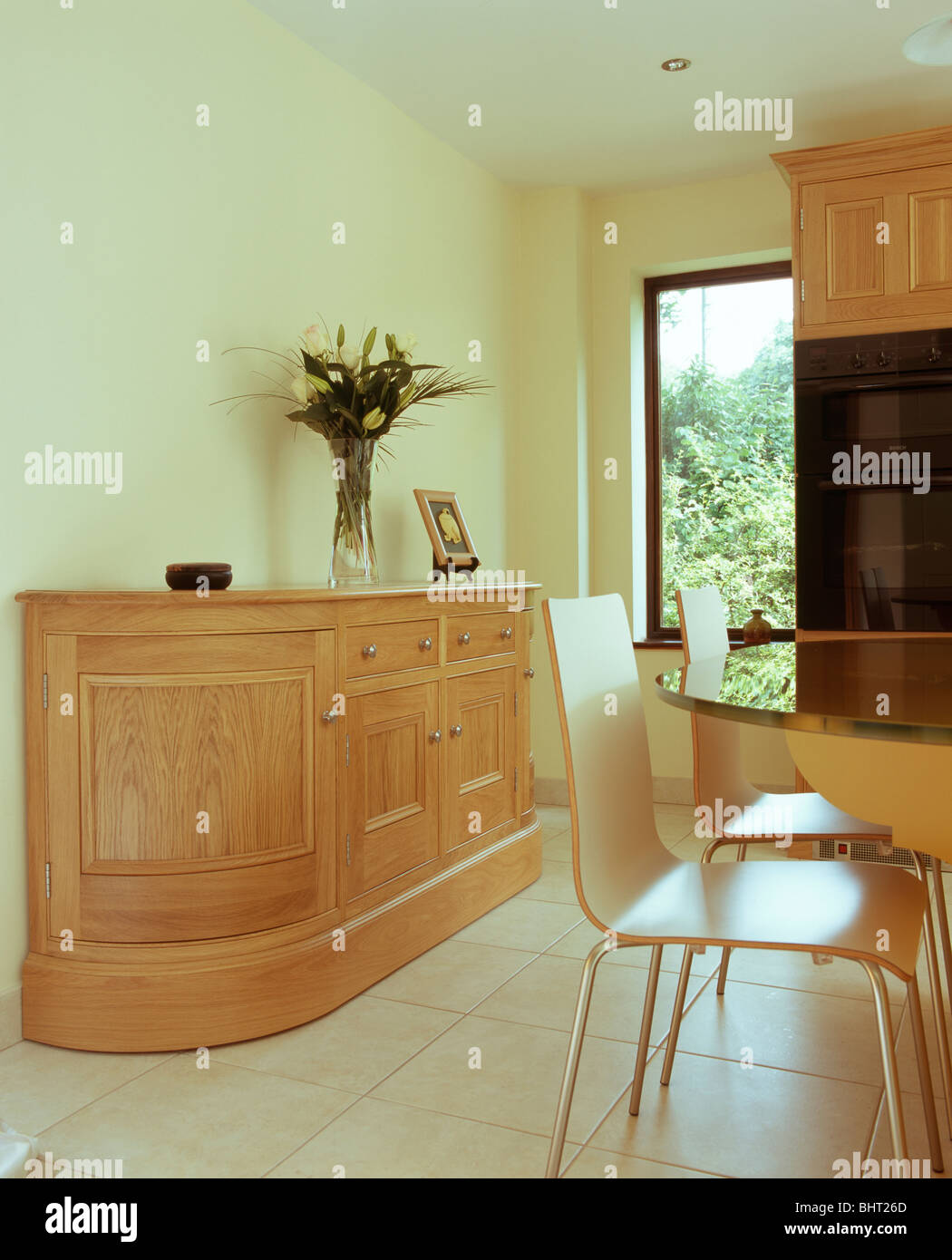 Fitted sideboard in modern cream kitchen dining room with cream