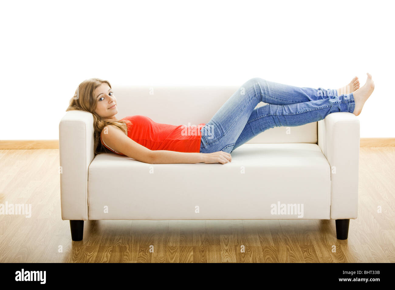 Beautiful young woman relaxing at home on the sofa Stock Photo - Alamy