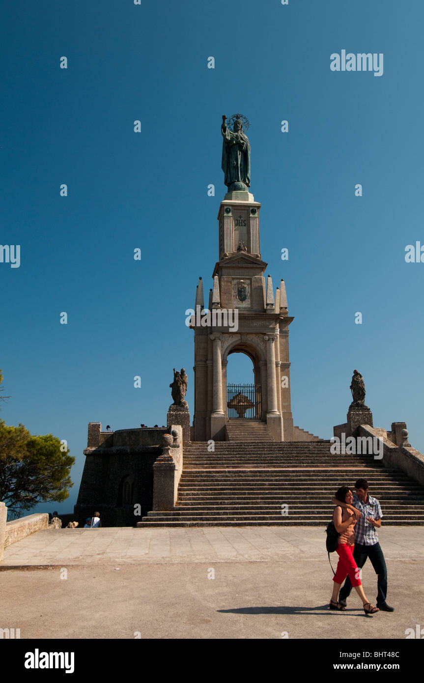 Two Young lovers walking near the  statue of San Salvatore Stock Photo