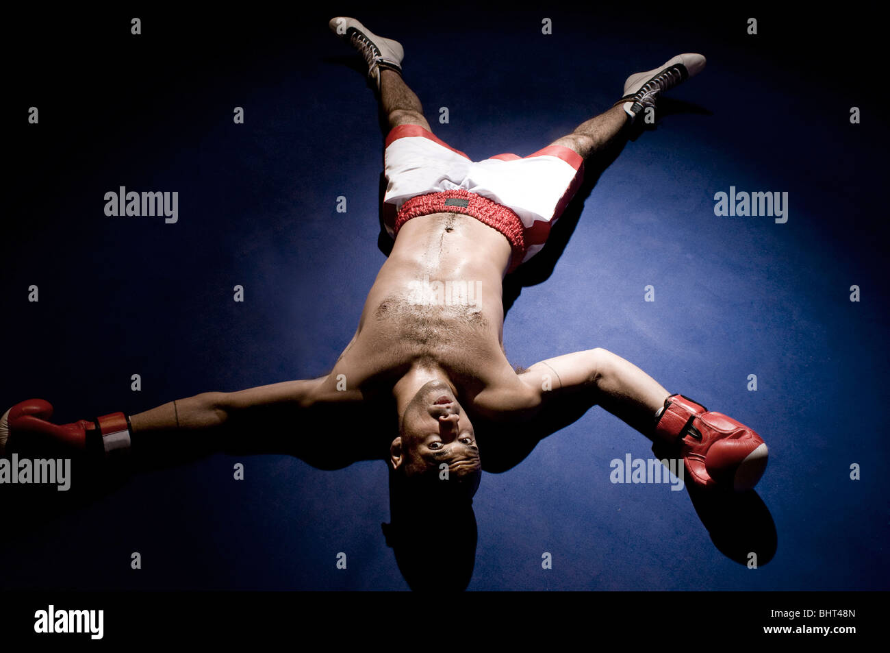 A boxer laid out in the ring Stock Photo