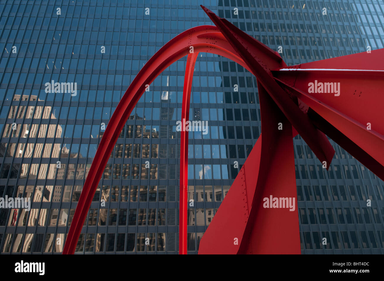 A reflection of the Willis Tower, formerly known as the Sears Tower pictured with Alexander Calder’s Flamingo sculpture Stock Photo