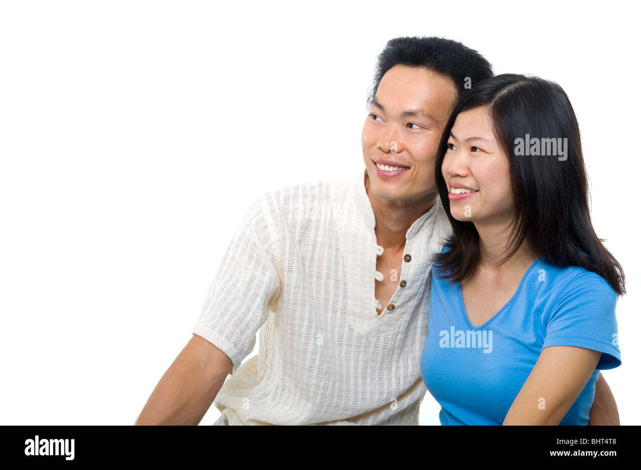 Young Asian couple sitting on sofa with smiling face, on white ...