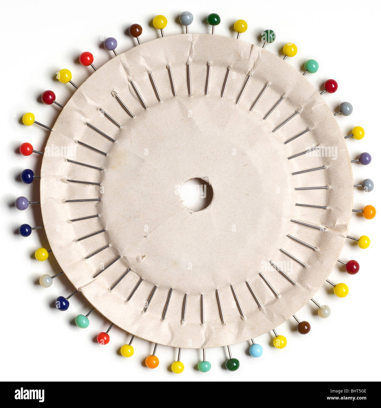 colorful head pins on a paper circle on white Stock Photo
