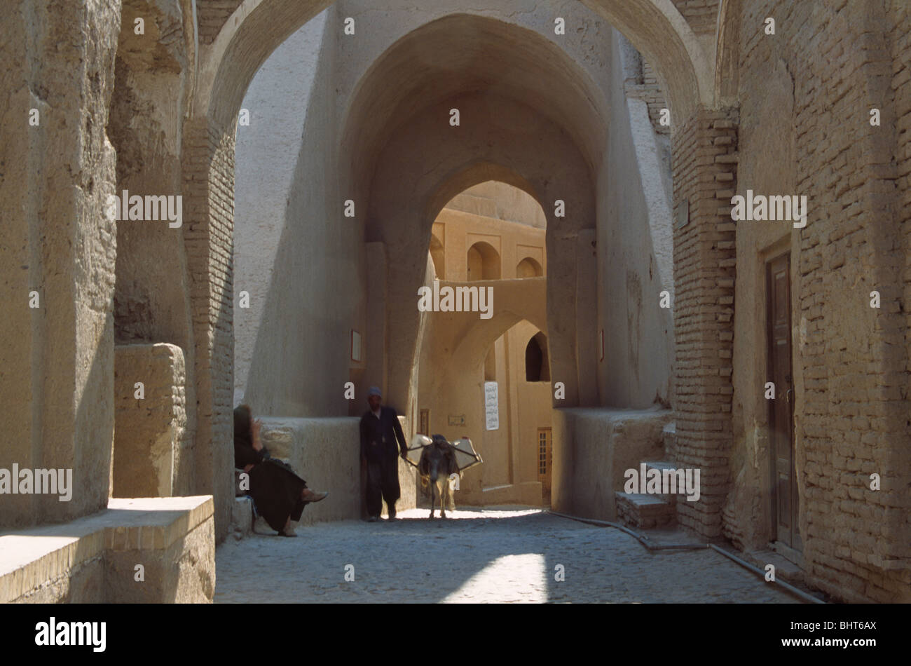Man with donkey inside ruined citadel of Arg-e Bam, Iran Stock Photo