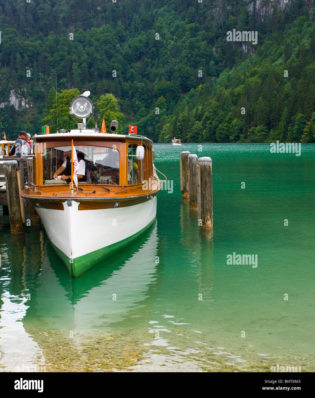 White boat on a lake between mountains Stock Photo - Alamy