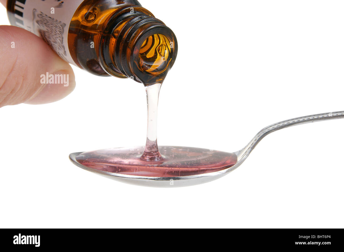 pouring of syrup on teaspoon with clipping path over white Stock Photo