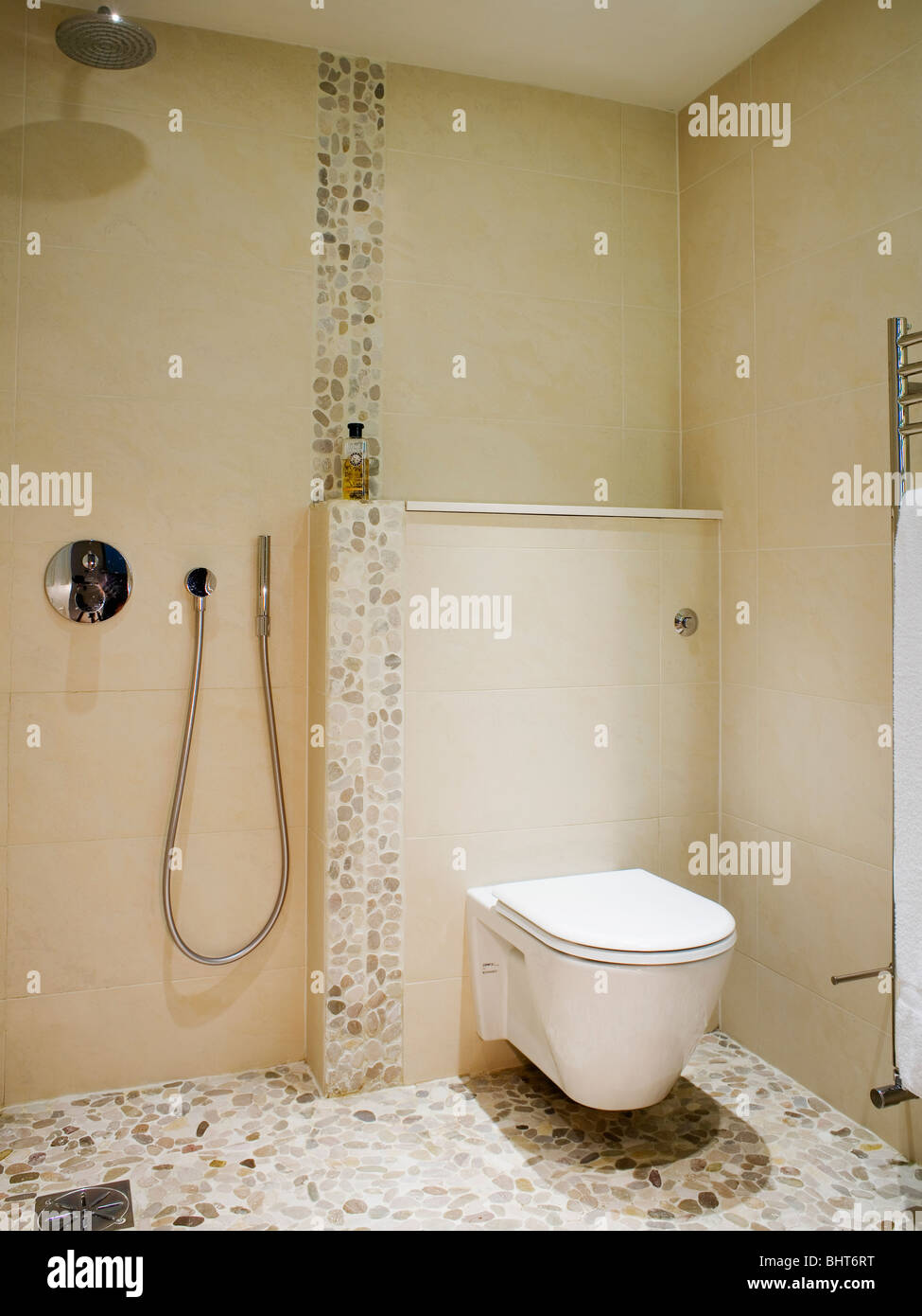 Toilet And Shower In Modern Cream Wet Room With Mosaic Tiled Floor