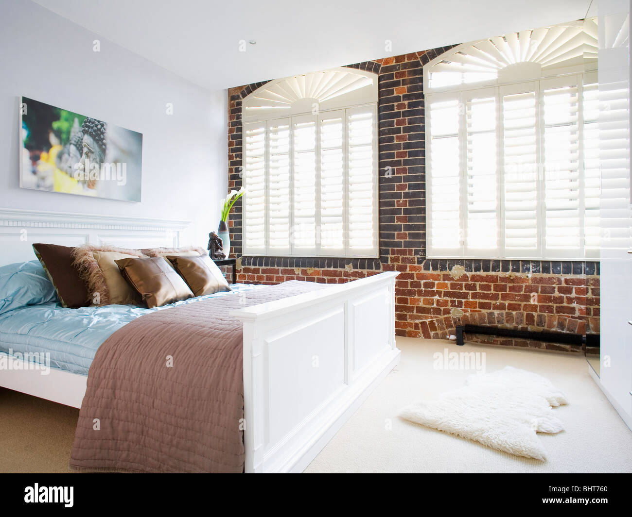 White Plantation Shutters On Window In Exposed Brick Wall In
