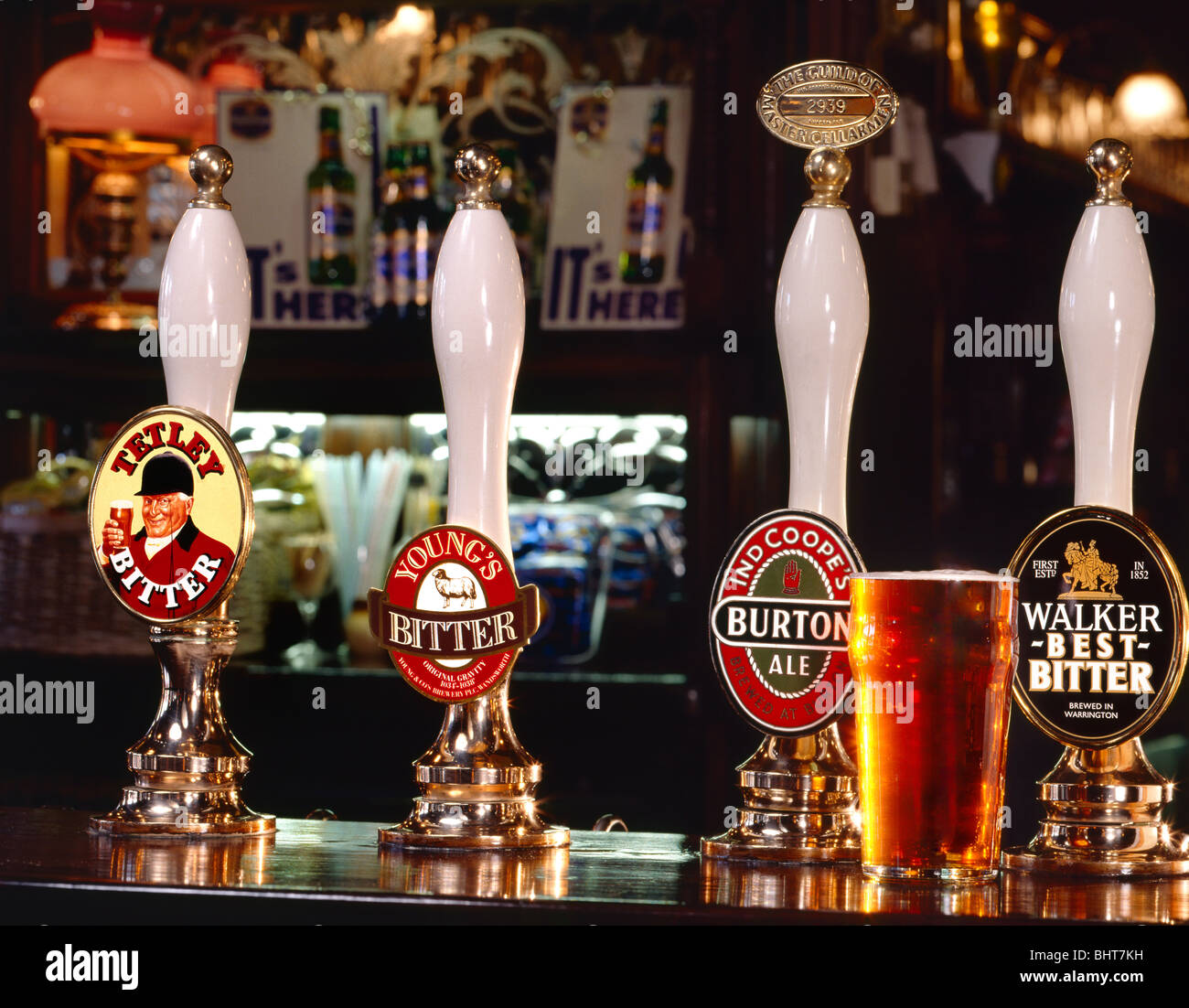 Pint of bitter served in typical atmospheric English pub with selection ...