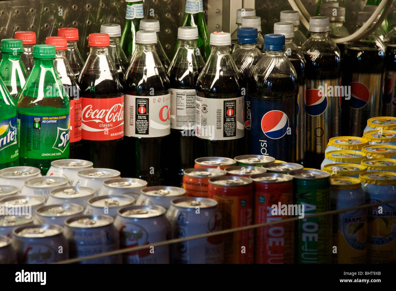 Soft drink bottles and cans in refrigerated case Stock Photo Alamy
