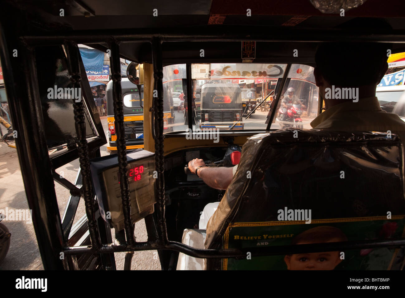 India, Kerala, Calicut, Kozhikode, local travel, view from inside moving autorickshaw with working meter Stock Photo