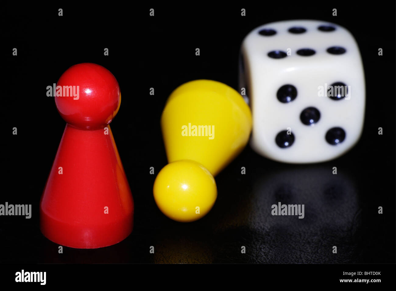 Two game pieces and a dice Stock Photo Alamy
