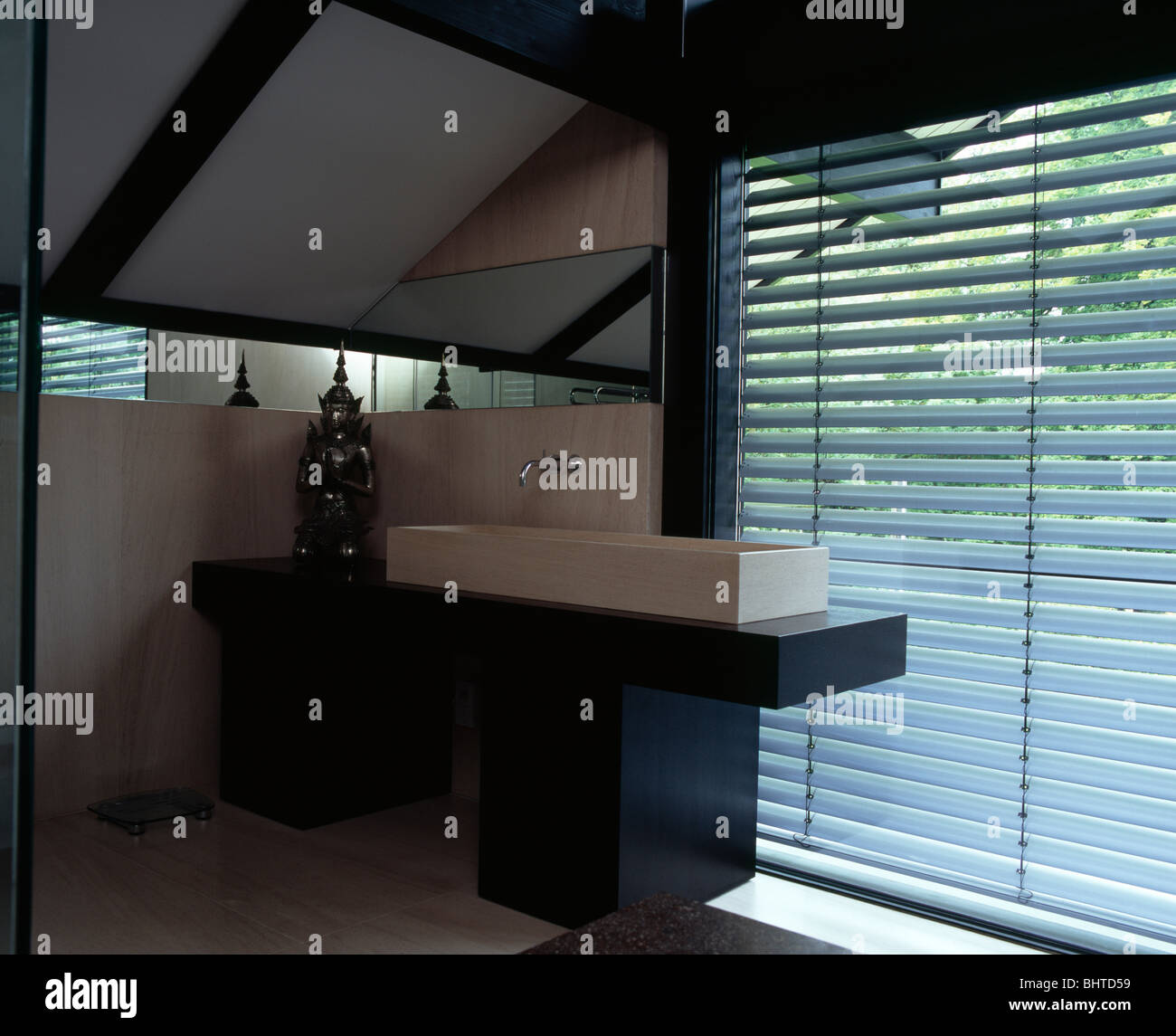Slatted blind on window behind rectangular basin on vanity unit in ...