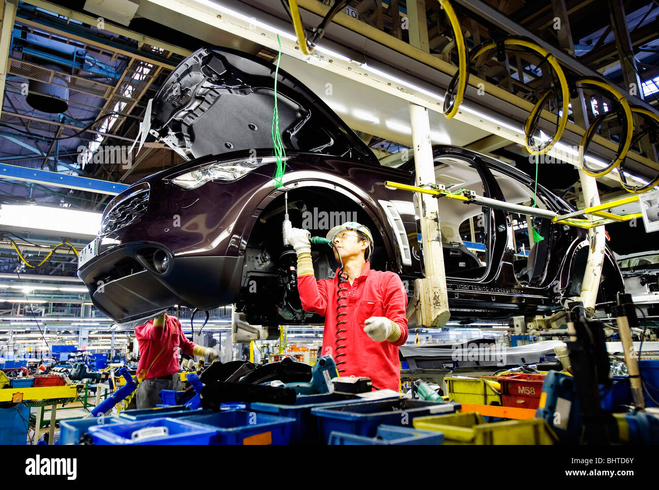 A worker works on a vehicle at Nissan Motor Co.s assembly plant in Tochigi, Japan Stock Photo