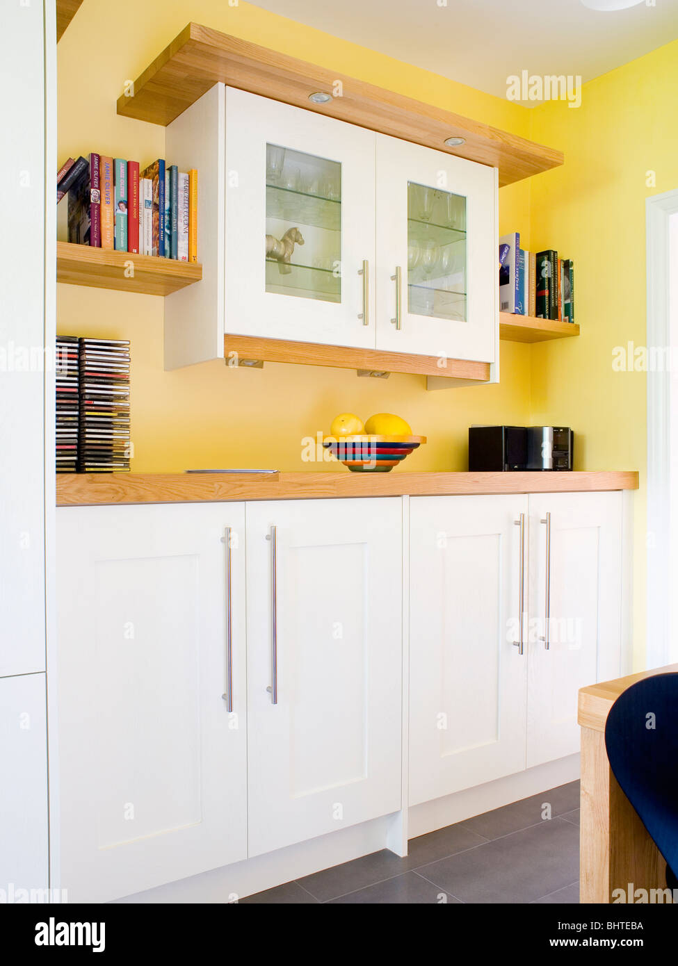 Wall Cupboard In Modern Yellow Kitchen With Fitted White Units Stock Photo Alamy