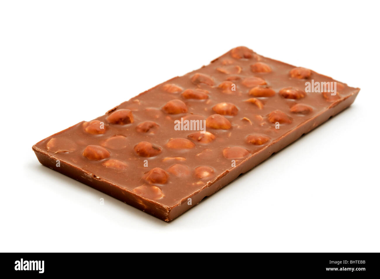 Milk chocolate with hazelnuts on a white background Stock Photo