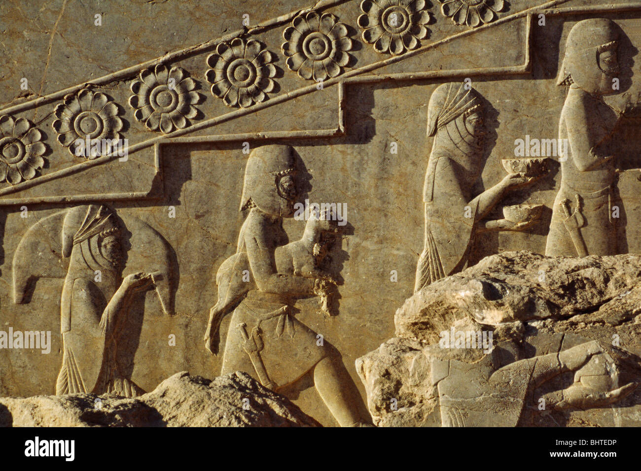 Relief sculpture vassals presenting gifts to honor ancient Persian rulers, Persepolis, Iran Stock Photo