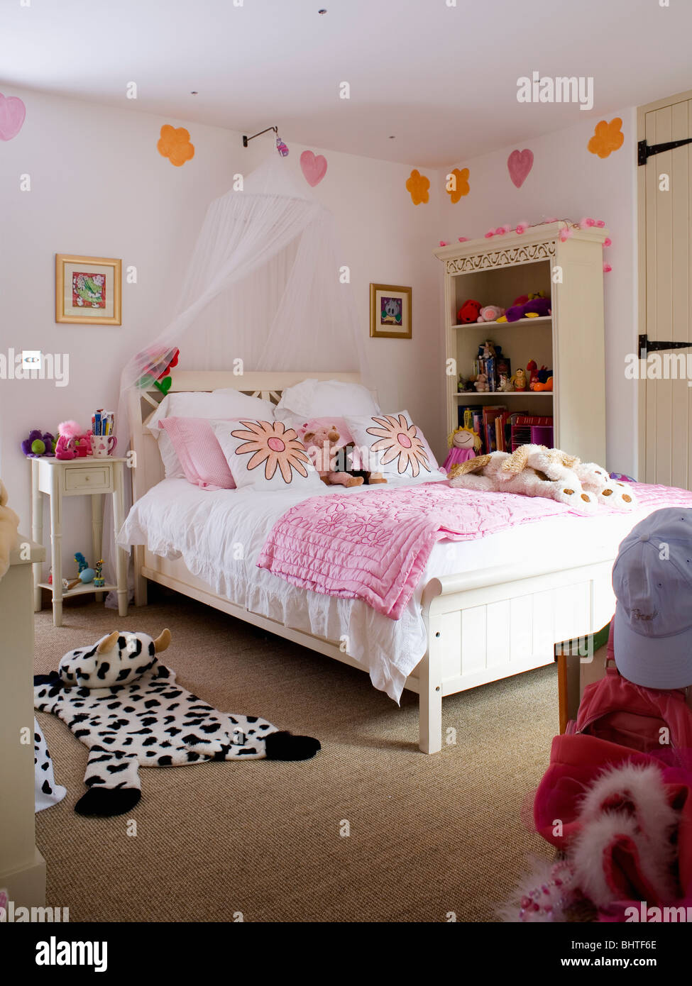White Voile Drapes Above Bed With Pink Quilt In Girl S Bedroom