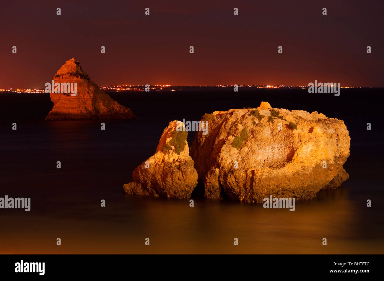 Illuminated rock in the sea at night in Algarve Stock Photo - Alamy