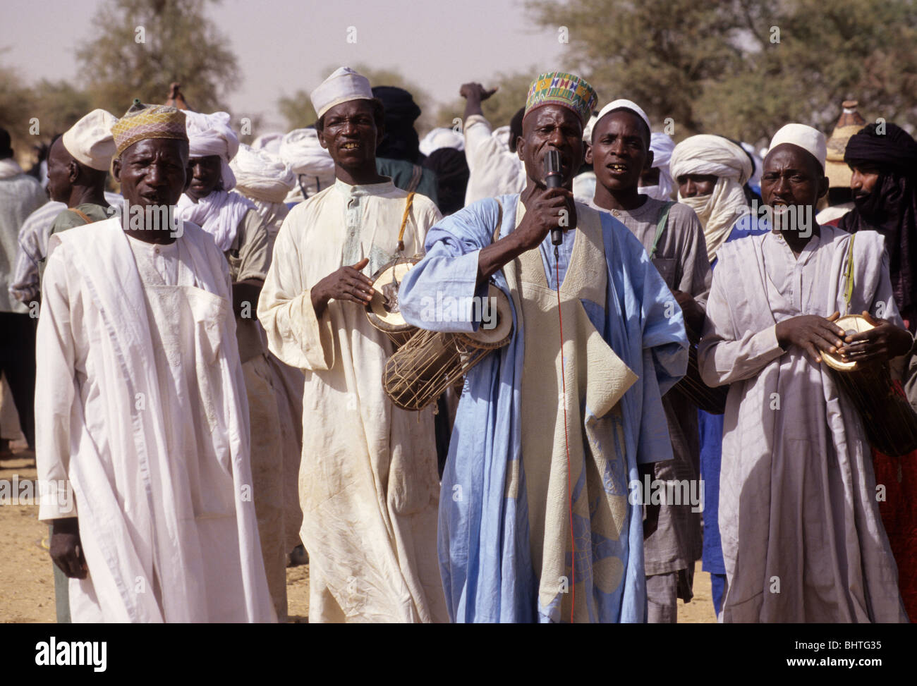 Akadaney, Central Niger, West Africa. Fulani Nomads. Men Welcoming Guests by Singing at Annual Gathering, a Gerewol. Stock Photo