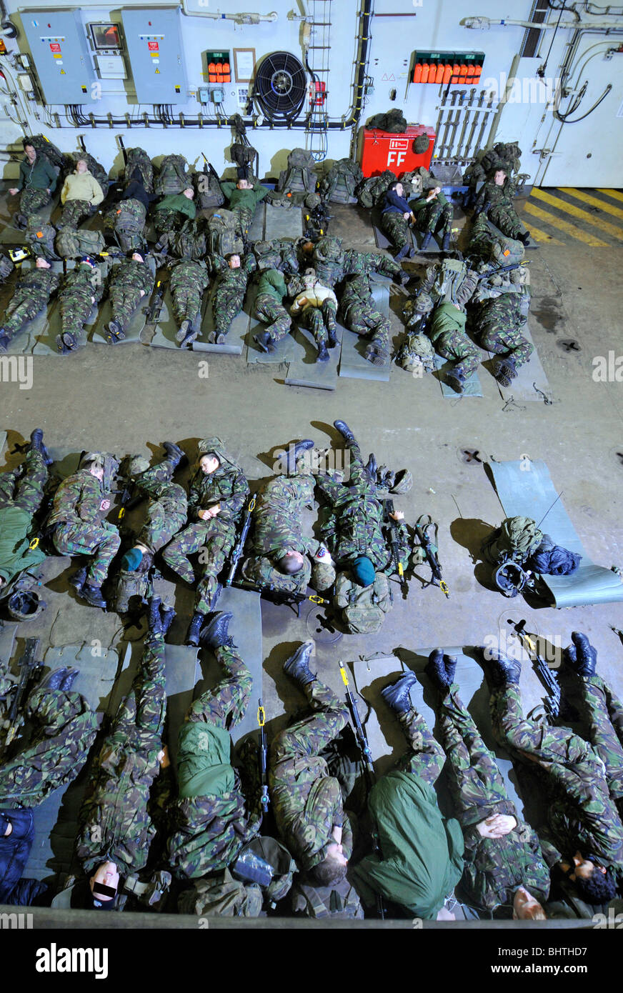 Soldiers asleep in a navy ship during transportation for deployment, troops sleeping Stock Photo